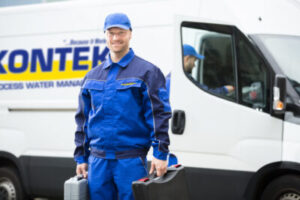 Kontek service technician standing in front of a Kontek service truck